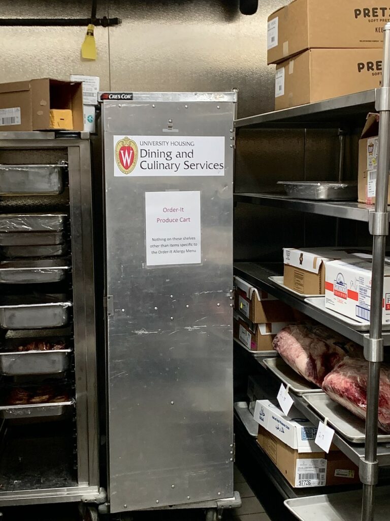 The ‘Order-It Produce Cart’ in the freezer room located inside the ‘chef’s prep’ at Gordon Avenue Market. The produce cart is a large, stainless-steel, rectangle-shaped freezer that rests on a wheeled platform.